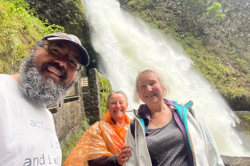 Marco Herrera with travelers at Pailón del Diablo waterfall in Baños, Ecuador