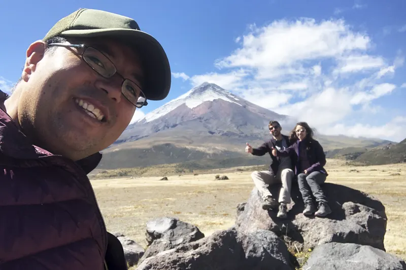 Marco Herrera with travelers at Cotopaxi National Park with the snow-capped volcano in the background