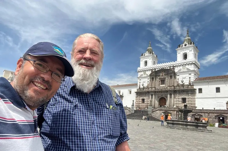 Marco Herrera with a traveler at San Francisco Square in Quito, Ecuador