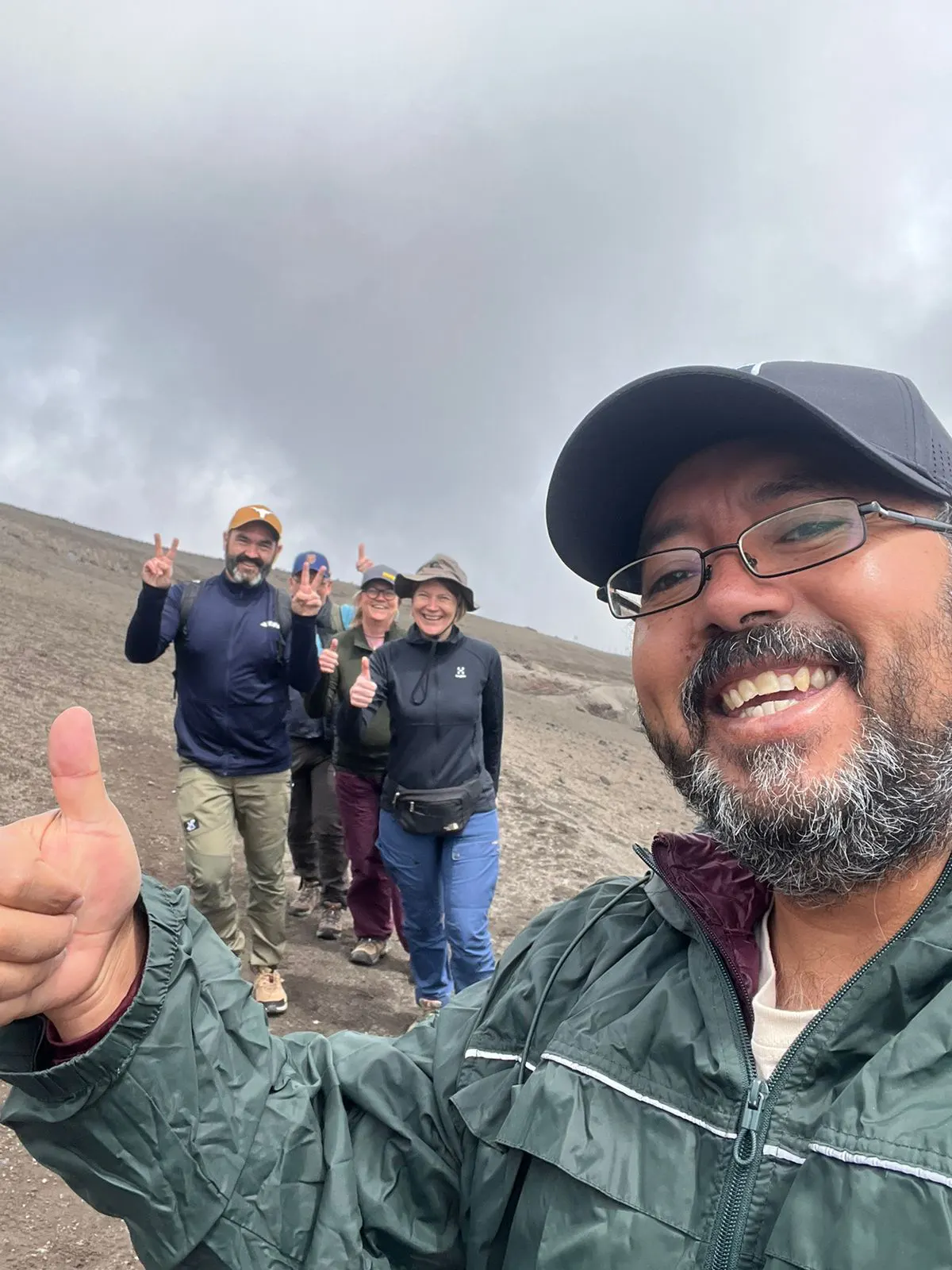 Travelers hiking on the slopes of Cotopaxi Volcano with Marco Herrera during a private tour in Ecuador